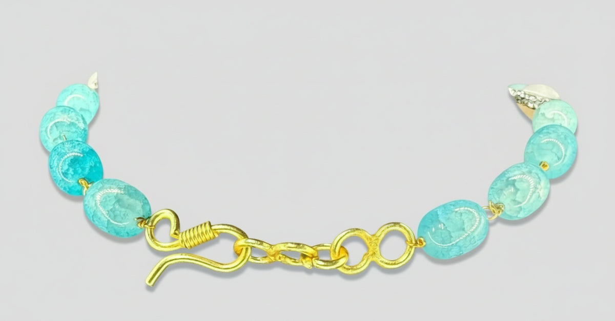 Necklace with colourful beads on a black mannequin bust against a grey background