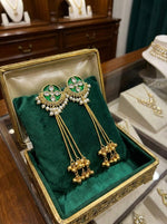 Ornate jhumkas adorned with bottle green crystal accents and matching green teardrop droplets.