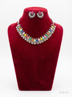 Ornate silver-toned stud earrings designed with a vibrant hot pink gemstone centerpiece for a bold pop of color.