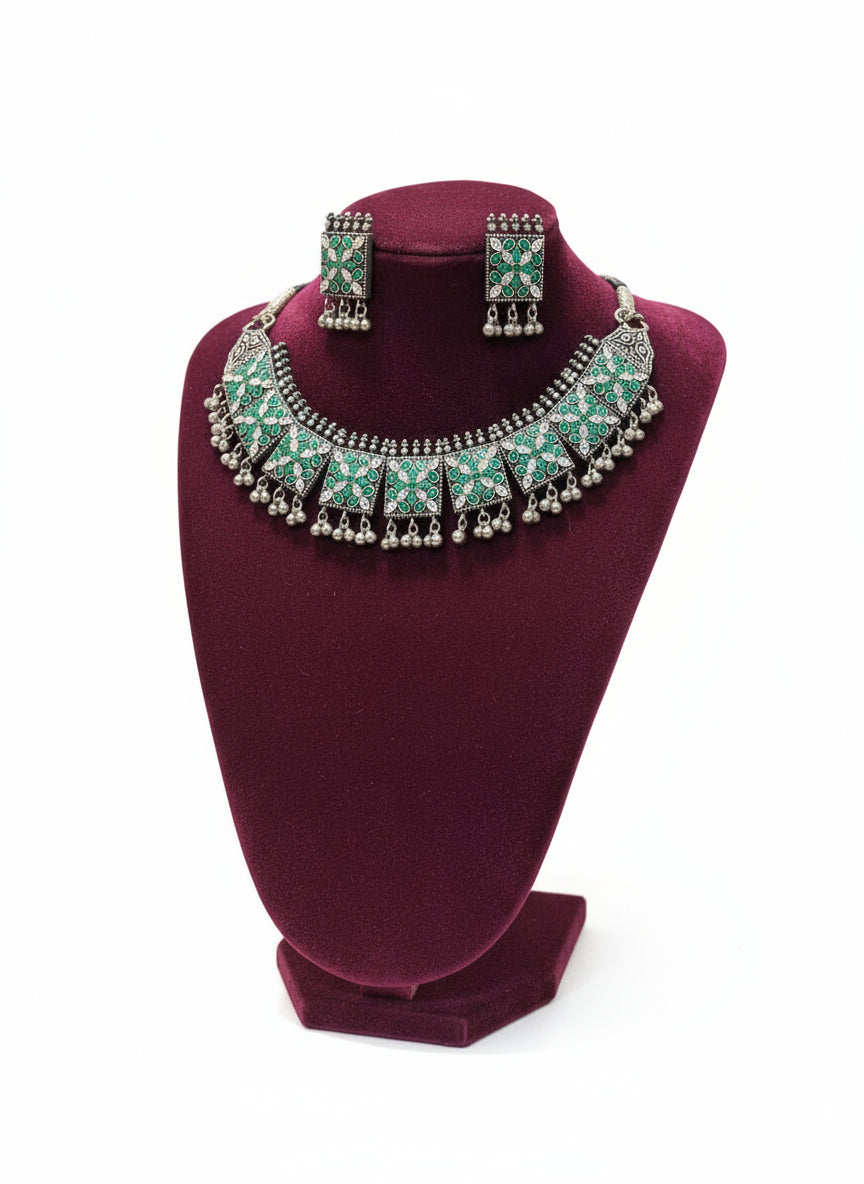 Jewellery set with necklace and earrings on a black stand