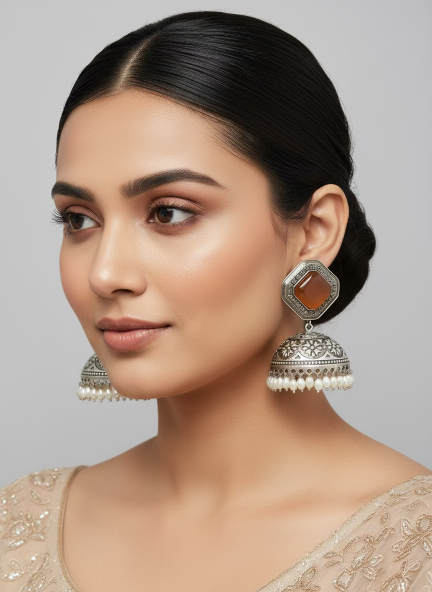 Oxidised jhumka earrings with golden stone