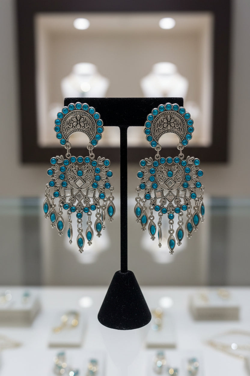 Oxidised silver earrings with blue stone detailed design