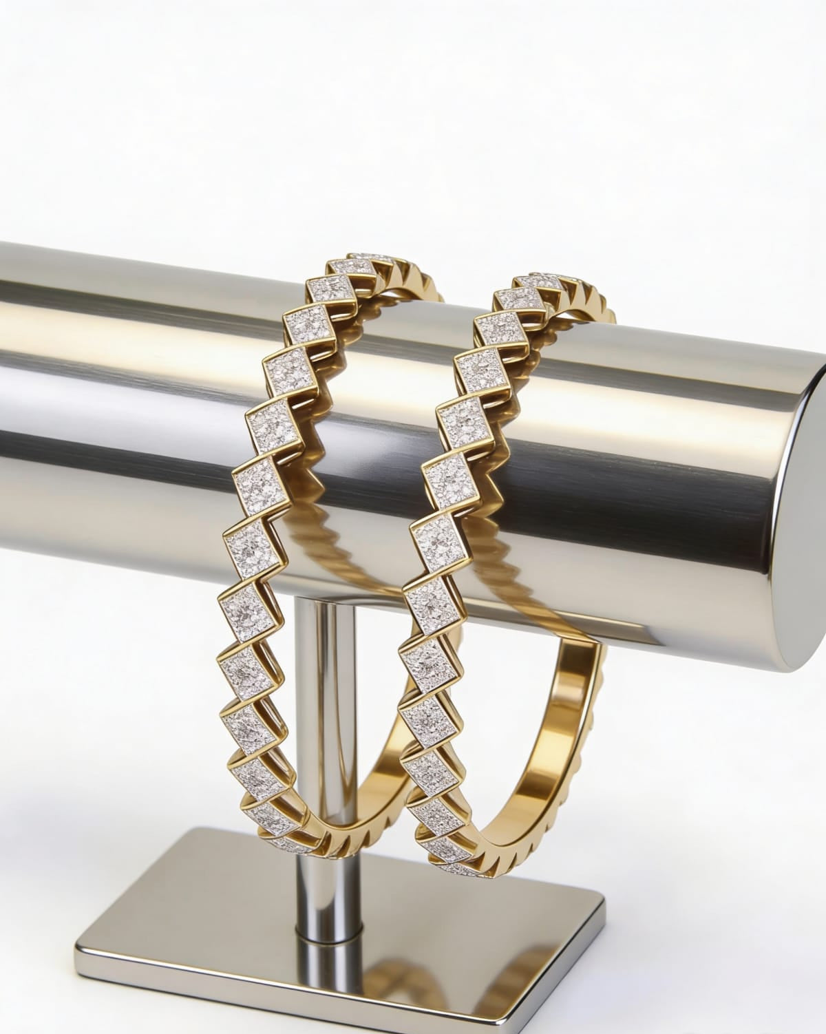 Gold bracelet with diamond accents on a metallic stand against a white background