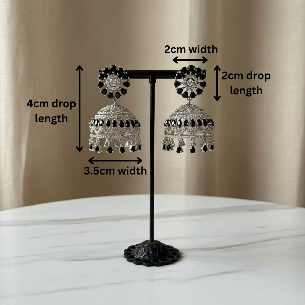 Pair of American diamond earrings with black stone on a stand with measurements indicated.