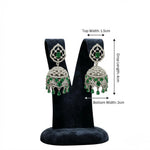 Pair of American diamond earrings with green gemstones.