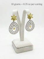 Pair of earrings on a white stand with weight information displayed.