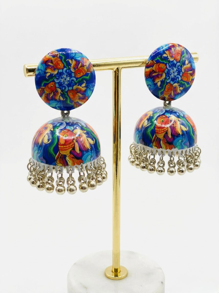 Pair of hand-painted enamel jhumka earrings featuring a vibrant blue Koi fish design with dangling metallic beads.