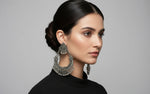Pair of silver earrings with intricate designs by famaza couture