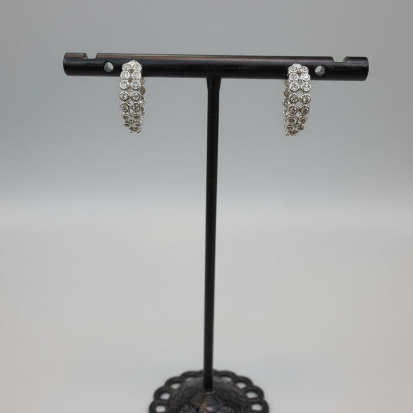 Pair of silver white stone curved bar earrings highlighting the 1.5cm length.