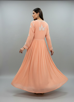 Peach-coloured long dress with white embroidery