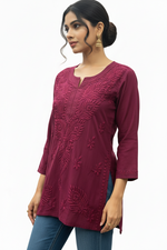 Plum handcrafted embroidered short kurti with intricate floral and leaf threadwork detailing on the neckline and hemline