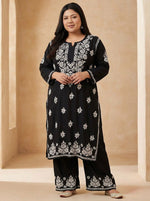 Plus size woman is wearing a black base rayon fabric 45 inches long kurti and 38 inches long trousers with white hand embroidered outfit on a white back