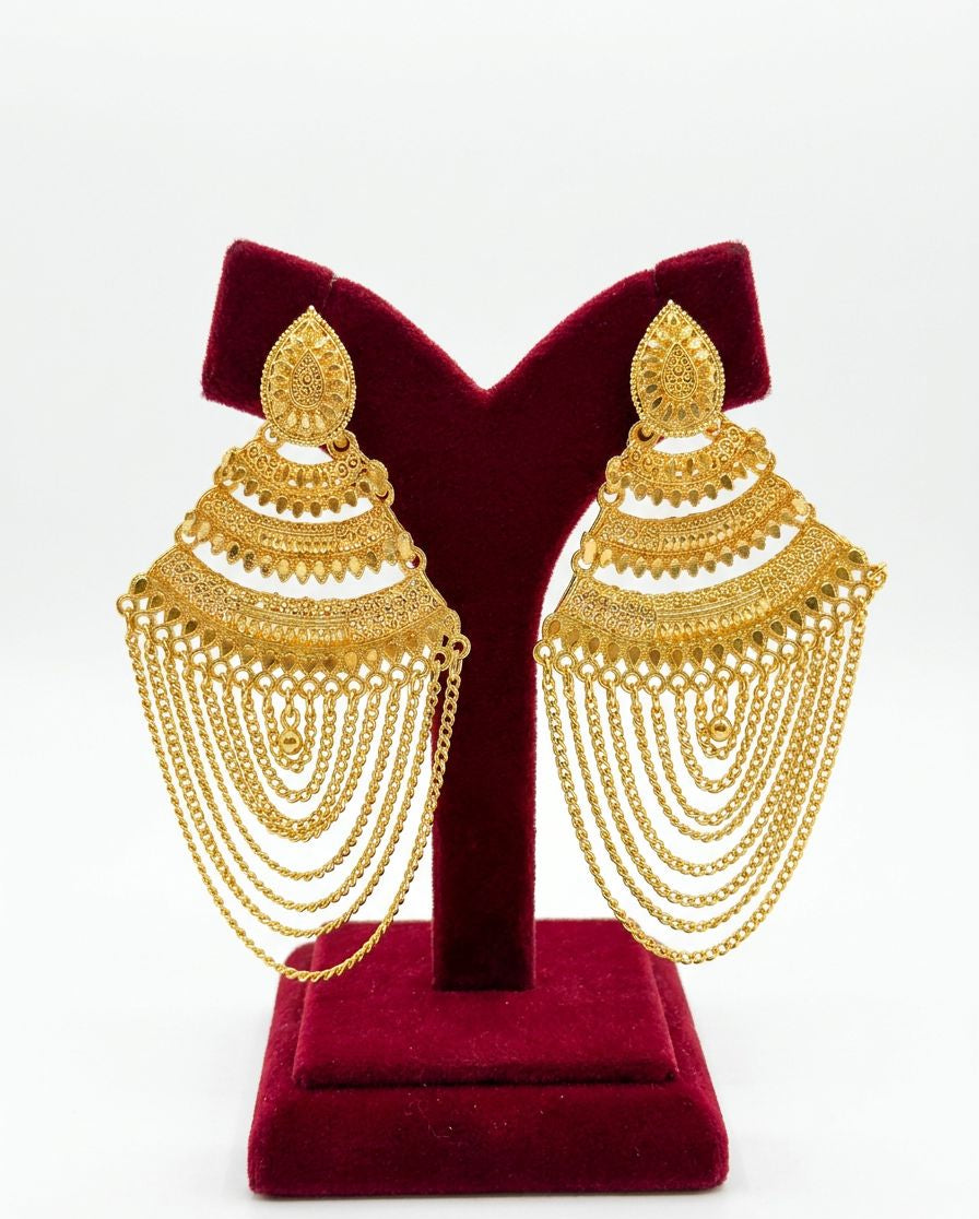 Royal Heritage 22K micro gold plated chandelier earrings with cascading multi-layered chains on a luxury maroon velvet stand.
