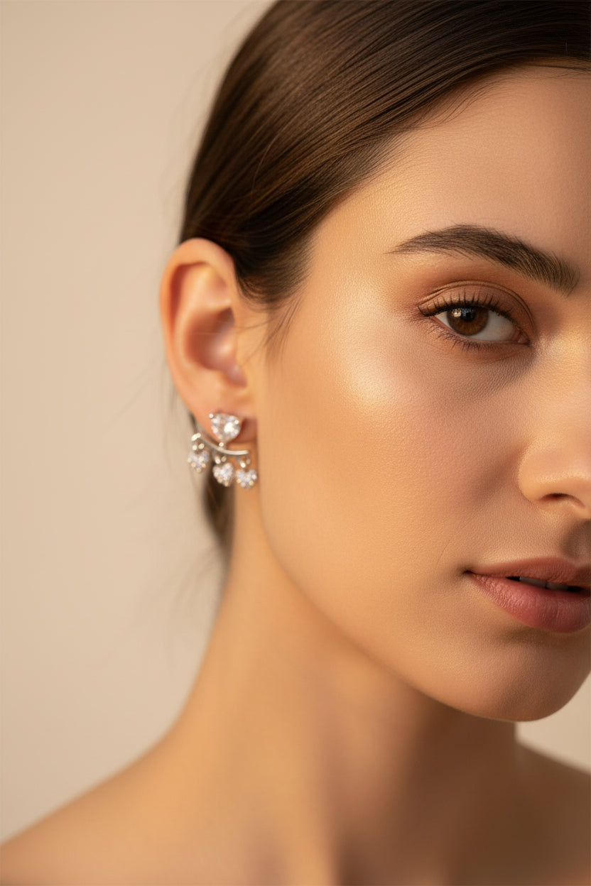 Professional shot of the Amara silver polish heart fringe earrings on a display stand, highlighting the brilliant white American Diamonds.