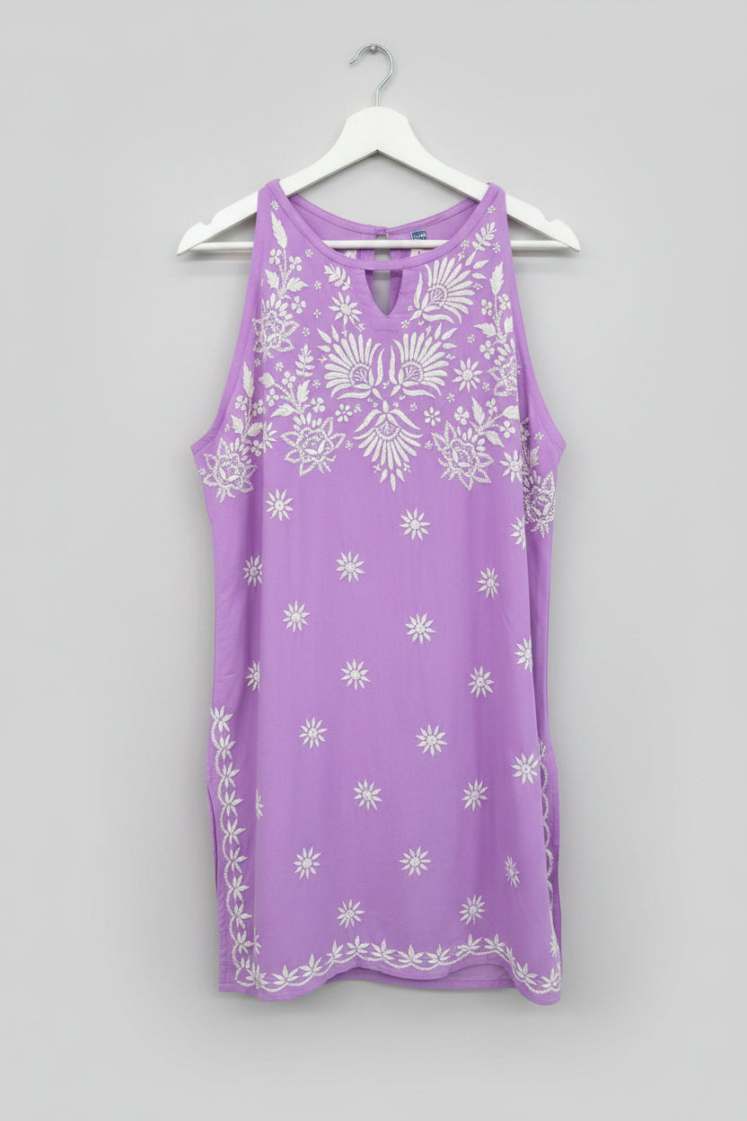 Purple sleeveless kurti with floral white hand embroidery all over the kurti is displayed.