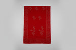 Red fabric with floral patterns on a gray background