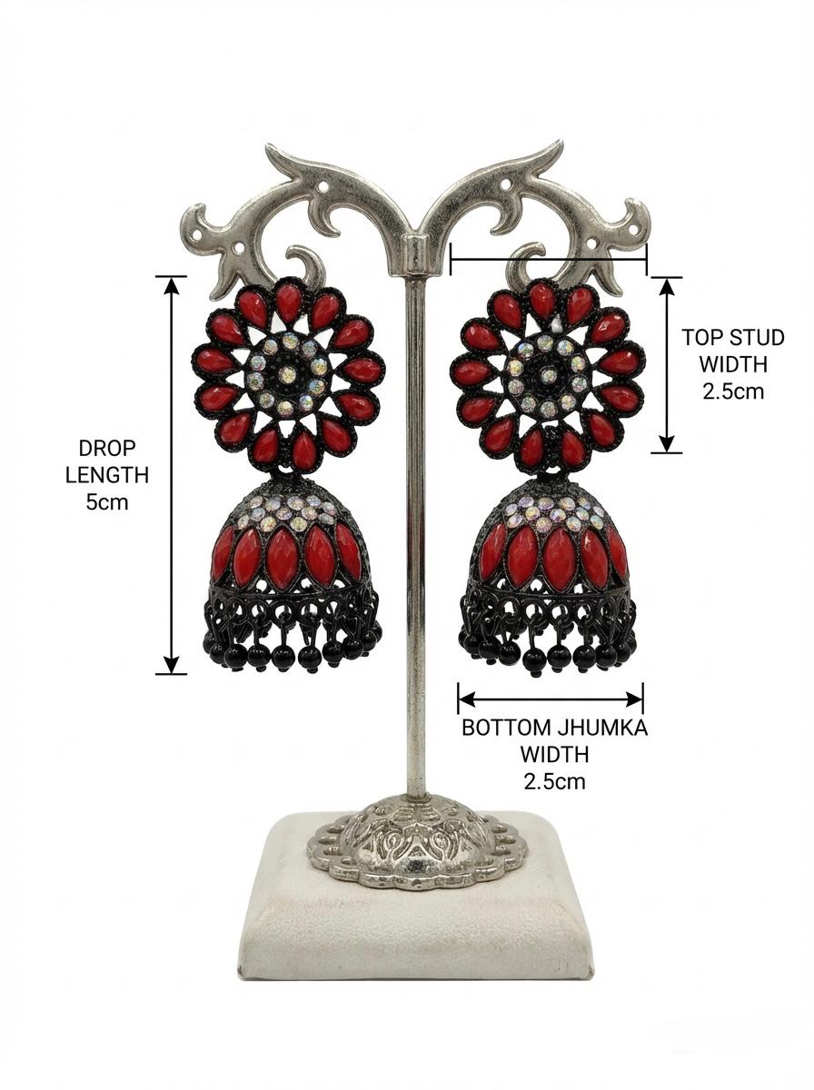Rich black brass jhumka earrings adorned with a deep maroon floral stone stud and matching maroon stone embellishments.