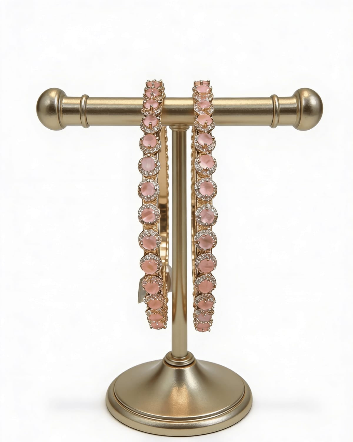 Rose Gold bracelets displayed on a stand.