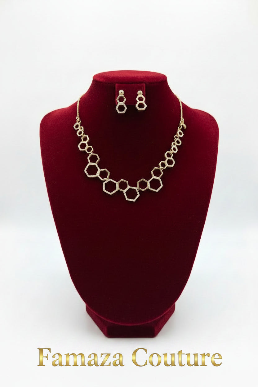 Rose Gold geometric link necklace and matching drop earrings displayed on a black velvet jewellery bust against a white background.