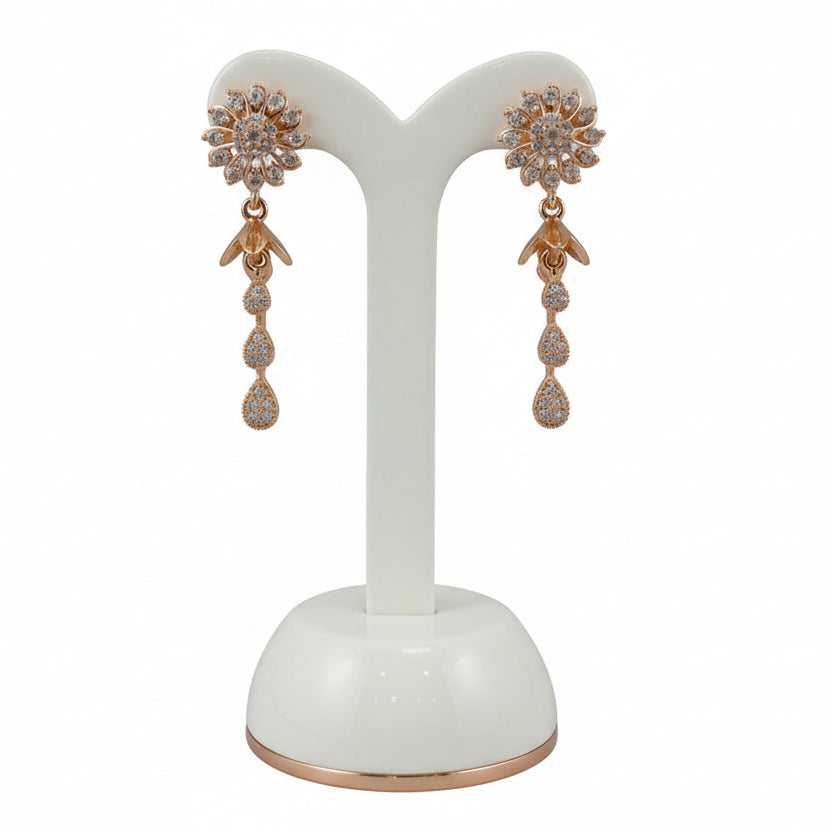 Rose gold polish American Diamond earrings with an intricate multi-petal floral design and tiered white stone charms.