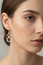 Rose gold polish American Diamond earrings with intricate lattice work and cascading white stone drops.