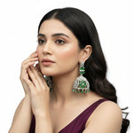 Round bali on top and jhumka in the bottom style earrings with silver AD stones and bottle green stones in flowers.
