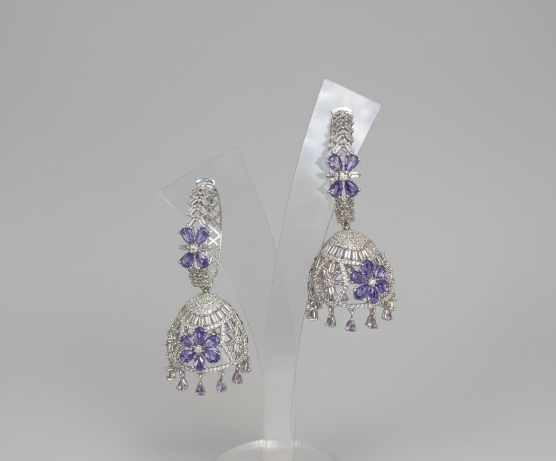 Round bali on top and jhumka in the bottom style earrings with silver AD stones and purple colour stones in flowers. Party wear earrings.