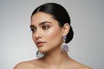 Round bali on top and jhumka in the bottom style earrings with silver AD stones and purple colour stones in flowers. Party wear earrings.