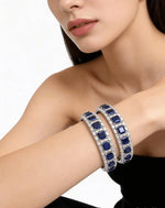 Model showcasing a royal sapphire blue American Diamond bangle set with a silver finish and baguette-cut stones.