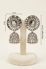 Silver-toned Indian jhumka earrings displayed on a cream-colored jewelry stand, with dimension lines indicating a 3 cm circular size and 6.5 cm drop length.
