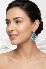 Amethyst teardrop earrings with halo diamond-style setting, perfect for formal occasions.