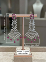 Pair of earrings on a stand with measurements and details.