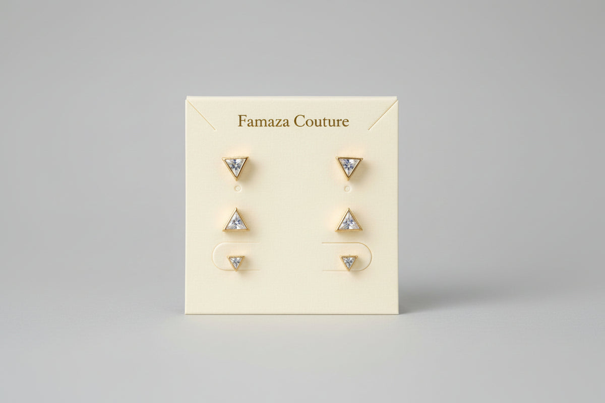 Set of three pairs of minimalist geometric triangle crystal stud earrings on A.P. Jewellery display card.