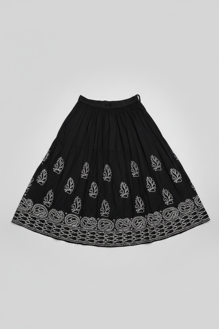 The Sharara with white thread bakhiya embroidery is shown as folded in double layer. Focus is embroidery.