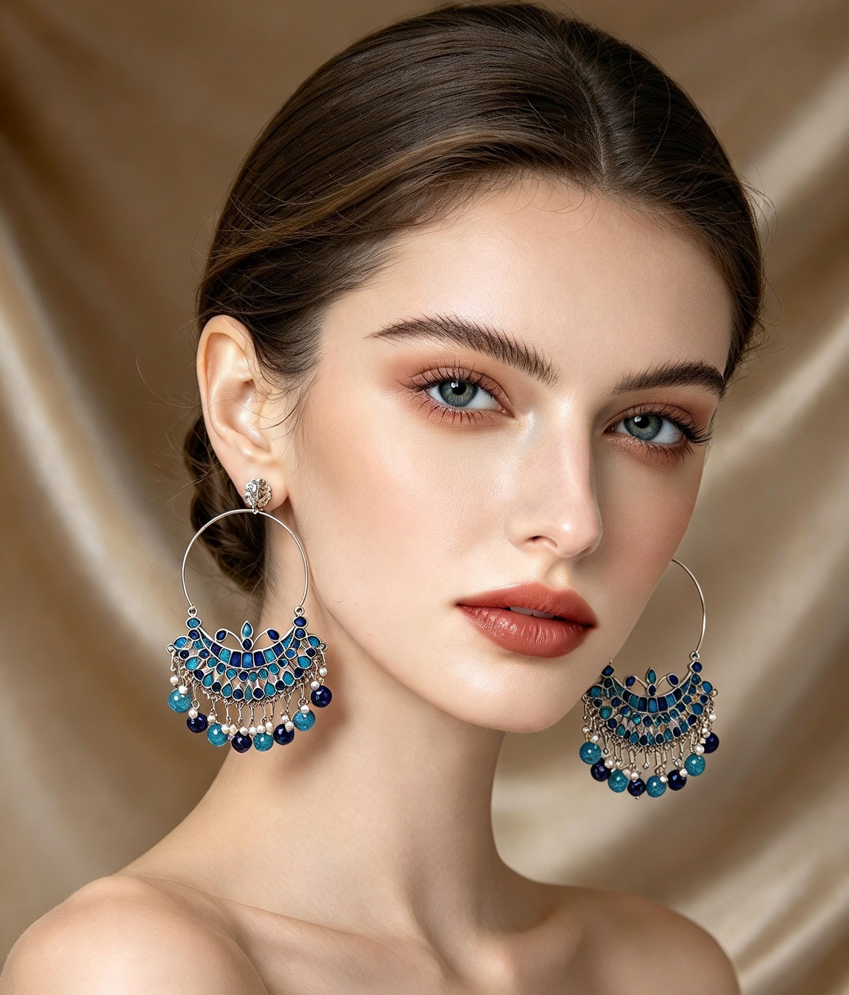 Model wearing silver-tone large hoop earrings with stone-studded chandbali design, cobalt blue and turquoise stones, white pearl detailing, dangling bead drops, premium Pakistani Indian bridal jewelry, soft champagne silk background.
