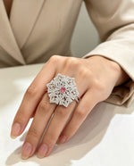 Close-up of hand wearing Elegant Silver & Pink American Diamond Ring — Luxury Collection by Famaza Couture, snowflake halo design with marquise-cut stones and pink center stone.