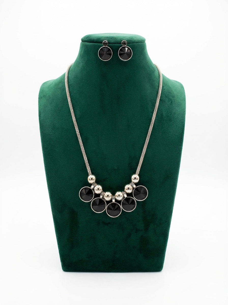 Silver chained with black kundan stones A long necklace and matching stud earrings .