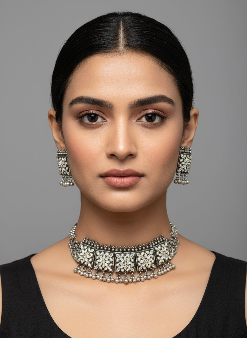 Silver jewellery set on a black mannequin with a blurred background