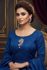 Silver plated a set of peacock-shaped pendant in silver chain with peacock-shaped earrings. The pendant is detailed with blue enamel and has sparkling crystal white AD and hot pink stones embellishments. Party wear jewellery set. Jewellery set is displayed on a black velvet jewellery dummy.