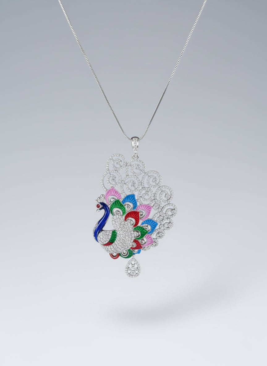 Silver polished a peacock pendant with vibrant green, blue, red and pink enamel accents, along with white AD stones sparkling embellishments. Pendant is focused to show the design.