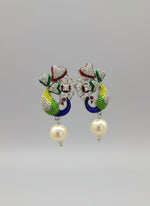 Silver polished peacock figureearrings with vibrant green, blue, and gold enamel accents, along with sparkling white ad stones embellishments. Earrings are focused to show the design.