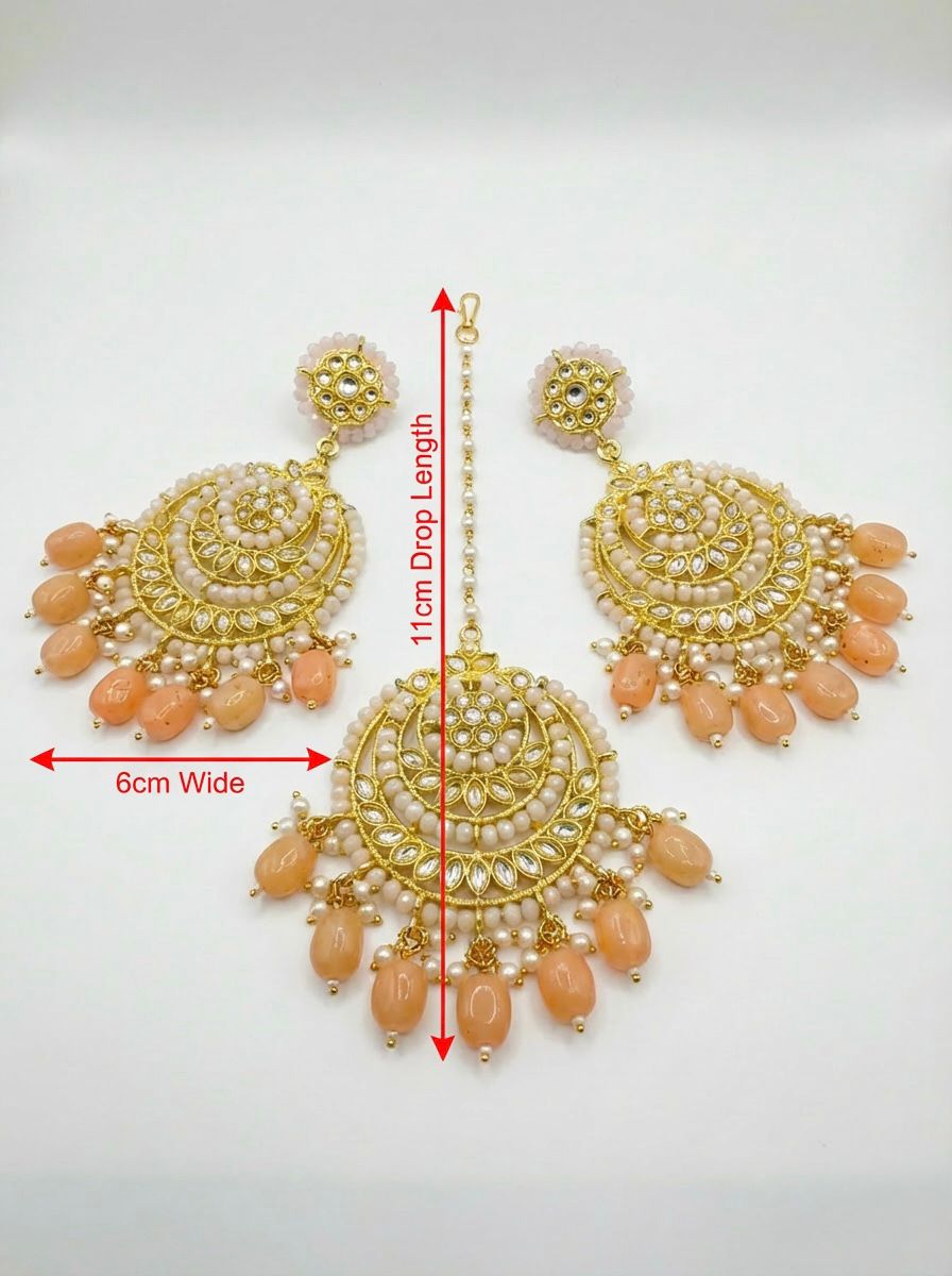 Sophisticated peach and rose gold ethnic earrings paired with a coordinating traditional outfit.