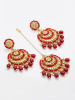 Sophisticated red and rose gold statement jewelry set against a traditional bridal ensemble.