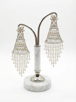 Sophisticated silver-toned tiered earrings with a delicate fringe of white pearl beads for festive occasions.