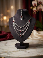 The AD triple layer cubic zirconia and hot pink centre stones necklace, earrings and maang tikka