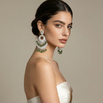 The American diamond earrings with bottle green stones.