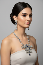 Model is wearing The American diamonds with navy blue cubic zirconia centre stones hasli necklace and earrings jewellery set