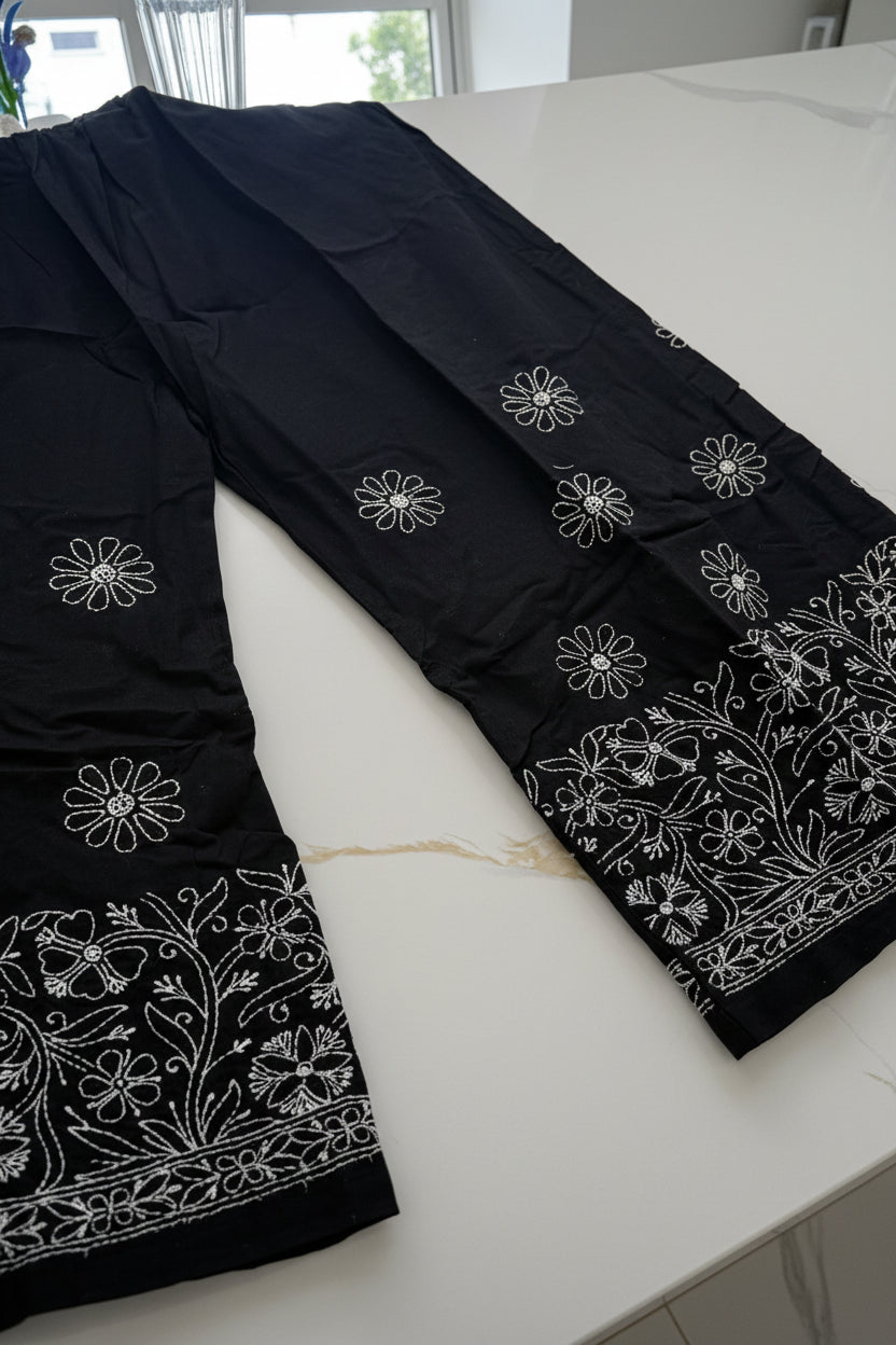 The Jet Black cotton loose fit trousers with white thread hand embroidery of bakhiya technique.