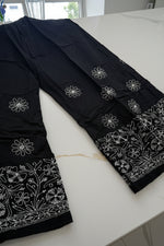 The Jet Black cotton loose fit trousers with white thread hand embroidery of bakhiya technique.