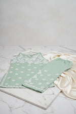 The Mint green colour sleeveless kurti and trousers with white hand embroidery is displayed next to each other on the hangers.